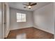 Bedroom with a neutral color scheme, wood-look floors, and a window at 7240 Wandering Star Ct, Las Vegas, NV 89131