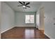 Spacious bedroom with hardwood floors, ceiling fan, and natural light from window at 7240 Wandering Star Ct, Las Vegas, NV 89131