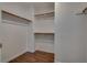 Walk-in closet featuring white walls, wood floors, and shelving at 7240 Wandering Star Ct, Las Vegas, NV 89131
