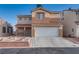 Charming two-story home with a desert landscaped yard and a covered entryway at 7240 Wandering Star Ct, Las Vegas, NV 89131
