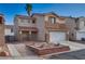 Two-story home with a two-car garage and desert landscaping at 7240 Wandering Star Ct, Las Vegas, NV 89131