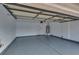 Spacious garage with epoxy flooring, water heater, and automatic garage door opener for modern convenience at 7240 Wandering Star Ct, Las Vegas, NV 89131