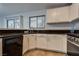 The kitchen has black granite countertops, white cabinets, stainless steel appliances, and a sink at 7240 Wandering Star Ct, Las Vegas, NV 89131