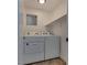 A dedicated laundry room with washer, dryer, and built-in shelving at 7240 Wandering Star Ct, Las Vegas, NV 89131