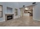 Open-concept living room with a fireplace and tile flooring that connects to kitchen at 7240 Wandering Star Ct, Las Vegas, NV 89131