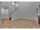 Bright, open living room with high ceilings, tile flooring, and staircase access at 7240 Wandering Star Ct, Las Vegas, NV 89131