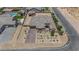 Aerial view of a home with desert landscaping, multiple outbuildings and tile roof at 7258 W Le Baron Ave, Las Vegas, NV 89178
