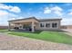 Inviting backyard with covered patio, artificial turf, and ample space for outdoor relaxation at 7258 W Le Baron Ave, Las Vegas, NV 89178