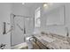 Clean, updated bathroom with glass shower and granite countertop at 7258 W Le Baron Ave, Las Vegas, NV 89178