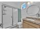 Bright bathroom features a shower with glass doors, and a granite countertop at 7258 W Le Baron Ave, Las Vegas, NV 89178