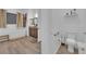 Bathroom featuring a modern tub, vanity, and separate toilet area for added convenience at 7258 W Le Baron Ave, Las Vegas, NV 89178