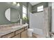 Charming bathroom with a round mirror, neutral color palette, and bright natural light at 7258 W Le Baron Ave, Las Vegas, NV 89178