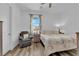Bright bedroom with a large window, comfortable chair, and cozy bedding at 7258 W Le Baron Ave, Las Vegas, NV 89178