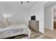 Bright bedroom with a large window, neutral walls, ceiling fan, and wood-look flooring at 7258 W Le Baron Ave, Las Vegas, NV 89178