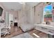 Bright bedroom with wood-look floors, pink walls, and a canopy bed at 7258 W Le Baron Ave, Las Vegas, NV 89178