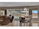 Stylish dining area features a large window and a contemporary chandelier at 7258 W Le Baron Ave, Las Vegas, NV 89178