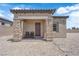 The house has a well-kept exterior with stone pillars and desert landscaping at 7258 W Le Baron Ave, Las Vegas, NV 89178