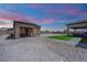 Backyard view with built in seating space and desert landscaping at 7258 W Le Baron Ave, Las Vegas, NV 89178
