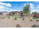 Charming single-story home featuring desert landscaping, stone accents, and a neutral color palette, captured on a sunny day at 7258 W Le Baron Ave, Las Vegas, NV 89178