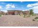 Charming single-story home featuring desert landscaping, stone accents, brick driveway, and a neutral color palette at 7258 W Le Baron Ave, Las Vegas, NV 89178