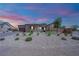 Charming single-story home with desert landscaping, a paver driveway, and a welcoming front entrance at 7258 W Le Baron Ave, Las Vegas, NV 89178