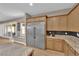 Modern kitchen features stainless steel refrigerator, breakfast nook, and granite countertops at 7258 W Le Baron Ave, Las Vegas, NV 89178