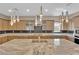 Beautiful kitchen features custom cabinets, granite countertops, and modern stainless hood at 7258 W Le Baron Ave, Las Vegas, NV 89178