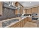 Beautiful kitchen showcasing stainless steel appliances, custom cabinetry, and granite countertops at 7258 W Le Baron Ave, Las Vegas, NV 89178