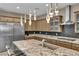 Stylish kitchen featuring stainless steel appliances, granite countertops, and custom cabinets at 7258 W Le Baron Ave, Las Vegas, NV 89178