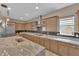 Gourmet kitchen with stainless appliances and a huge granite island with seating at 7258 W Le Baron Ave, Las Vegas, NV 89178