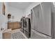 Modern laundry room equipped with updated washer and dryer, stainless steel refrigerator and sink at 7258 W Le Baron Ave, Las Vegas, NV 89178
