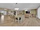 Open-concept living and dining area boasts sleek wood floors and modern lighting at 7258 W Le Baron Ave, Las Vegas, NV 89178