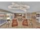 Open-concept living room with modern chandelier, hardwood floors, and access to the backyard at 7258 W Le Baron Ave, Las Vegas, NV 89178