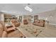Spacious living room featuring hardwood floors, a contemporary chandelier, and comfortable leather seating arrangements at 7258 W Le Baron Ave, Las Vegas, NV 89178