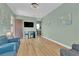An open living room with wood floors, modern decor, and a view to the front yard at 7258 W Le Baron Ave, Las Vegas, NV 89178