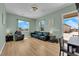 Bright living room featuring hardwood floors, natural light, and contemporary furnishings at 7258 W Le Baron Ave, Las Vegas, NV 89178