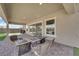 This covered patio has outdoor seating around a built-in stone fire pit at 7258 W Le Baron Ave, Las Vegas, NV 89178
