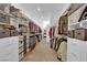 Spacious walk-in closet with custom shelving, drawer storage, and racks for optimal organization at 7258 W Le Baron Ave, Las Vegas, NV 89178