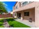 Backyard features artificial turf, concrete patio, and view of the second-story balcony at 7325 Perkins Hill St, Las Vegas, NV 89166