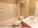 Clean bathroom featuring a shower-tub combo, a wooden cabinet, and a white toilet at 7325 Perkins Hill St, Las Vegas, NV 89166