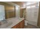 Bathroom with double sinks, neutral tile, and a shower at 7325 Perkins Hill St, Las Vegas, NV 89166