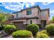 Charming two-story home with a brick driveway, lush landscaping, and a two car garage at 7325 Perkins Hill St, Las Vegas, NV 89166