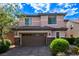 Charming two-story home with a brick driveway and lush landscaping, plus a two car garage at 7325 Perkins Hill St, Las Vegas, NV 89166
