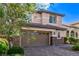 Charming two-story home with a brick driveway and lush landscaping, plus a two car garage at 7325 Perkins Hill St, Las Vegas, NV 89166