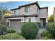 Inviting two-story home featuring a two-car garage, manicured landscaping, and brick driveway at 7325 Perkins Hill St, Las Vegas, NV 89166
