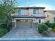 Inviting two-story home with a two-car garage, tidy landscaping and a brick driveway at 7325 Perkins Hill St, Las Vegas, NV 89166