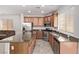 Bright kitchen with an island, stainless steel appliances, and wooden cabinets, seamlessly blending modern style at 7325 Perkins Hill St, Las Vegas, NV 89166