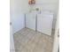 Small laundry room with tile flooring, utility sink and washer and dryer at 7325 Perkins Hill St, Las Vegas, NV 89166