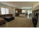 Spacious open floor plan featuring a kitchen, dining area, and living area with carpet at 7325 Perkins Hill St, Las Vegas, NV 89166