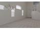 Bright living room featuring carpeted floors, neutral walls, staircase access, and natural lighting at 7325 Perkins Hill St, Las Vegas, NV 89166